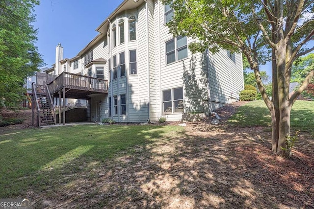 back of property featuring a lawn, stairs, and a deck