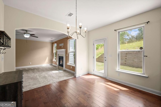 3940 Village Estates Ct, Cumming, GA 30040 - unfurnished living room with arched walkways, wood-type flooring, a glass covered fireplace, a ceiling fan, and a chandelier