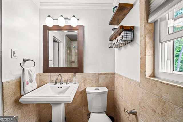 331 Lakemoore Dr NE Unit C, Atlanta, GA 30342 - bathroom with crown molding, toilet, and tile walls