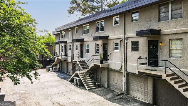 331 Lakemoore Dr NE Unit C, Atlanta, GA 30342 - townhome / multi-family property featuring a garage, stairs, and stucco siding