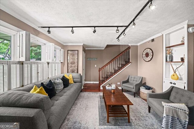 331 Lakemoore Dr NE Unit C, Atlanta, GA 30342 - living room featuring ornamental molding, dark wood-style flooring, stairs, baseboards, and a textured ceiling