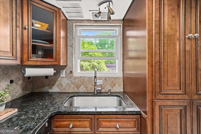 331 Lakemoore Dr NE Unit C, Atlanta, GA 30342 - kitchen with a sink, glass insert cabinets, backsplash, and brown cabinets