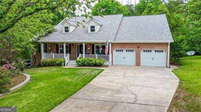 cape cod-style house featuring covered porch, driveway, a garage, brick siding, and a front lawn