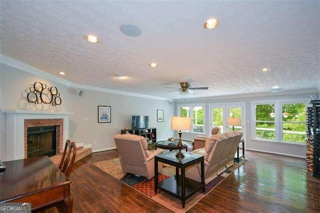living room featuring crown molding, recessed lighting, a fireplace, and wood-type flooring