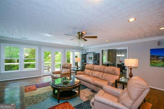 living area with crown molding, wood finished floors, baseboards, recessed lighting, and ceiling fan with notable chandelier