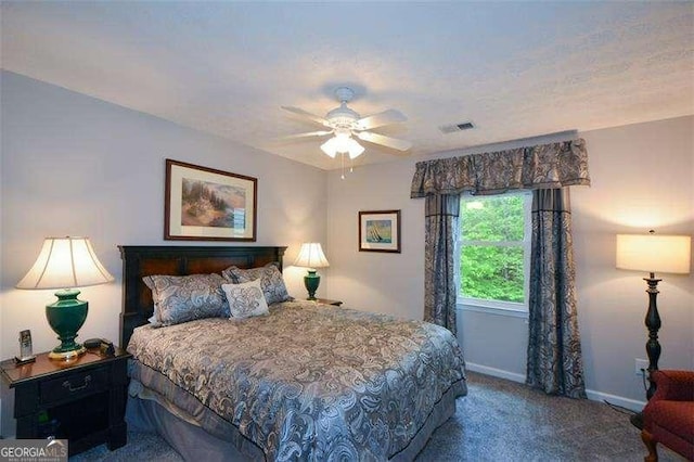 carpeted bedroom featuring baseboards, visible vents, and ceiling fan