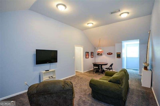carpeted living area featuring visible vents, baseboards, and vaulted ceiling