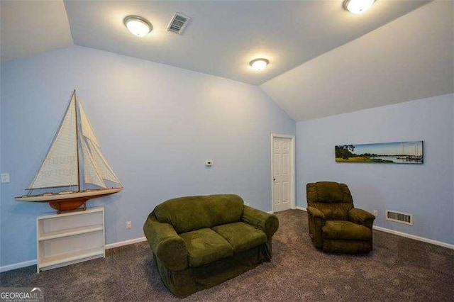 sitting room with carpet floors, vaulted ceiling, and visible vents
