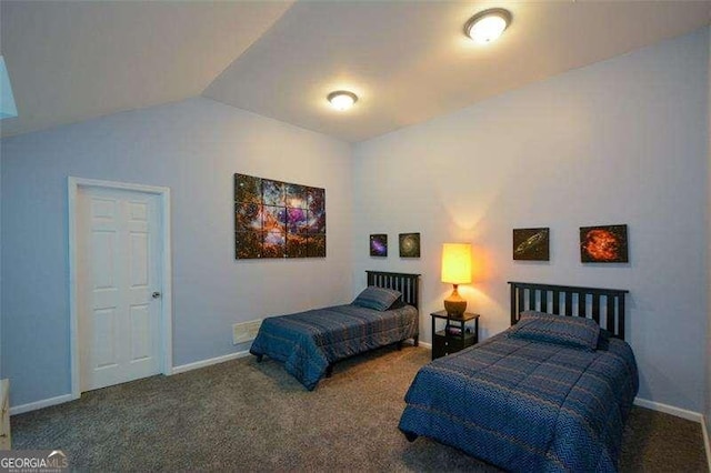 bedroom featuring baseboards, carpet flooring, and vaulted ceiling