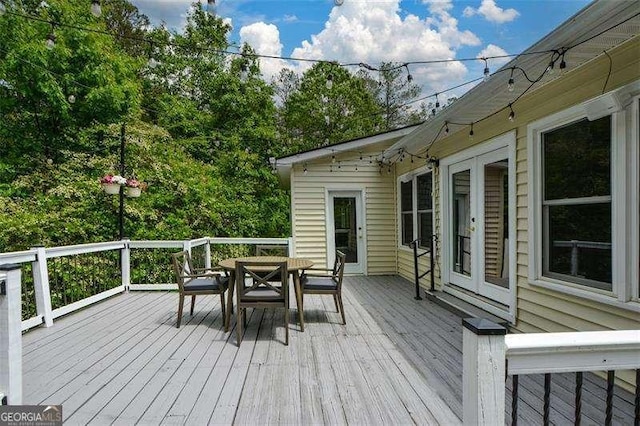 wooden deck featuring outdoor dining area