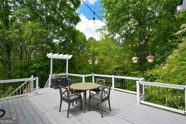 wooden deck with outdoor dining space