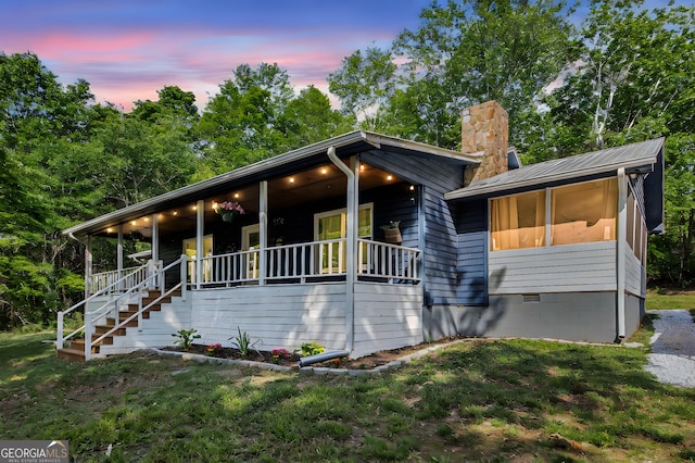 211 Phillips St, Clarkesville, GA 30523 - view of front facade with a porch, a chimney, crawl space, and stairs