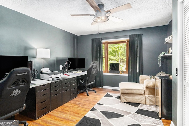 211 Phillips St, Clarkesville, GA 30523 - home office featuring a ceiling fan, light wood finished floors, and a textured ceiling