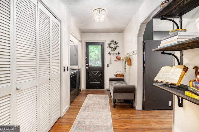 211 Phillips St, Clarkesville, GA 30523 - foyer entrance featuring wood finished floors and washing machine and dryer