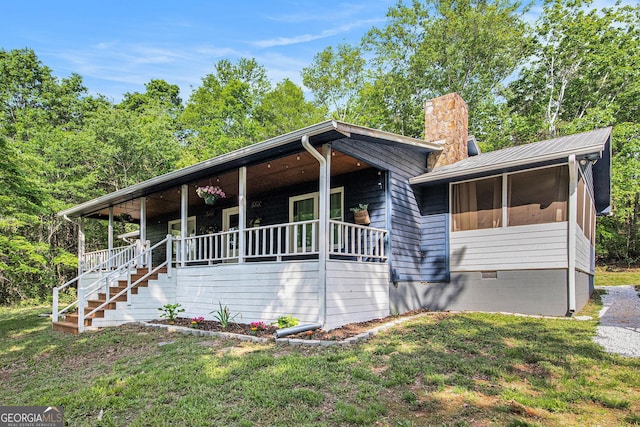 211 Phillips St, Clarkesville, GA 30523 - view of front of home featuring covered porch, a chimney, stairway, a front yard, and crawl space