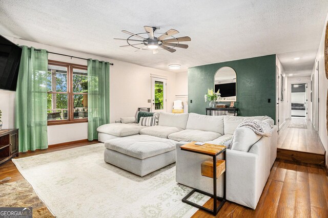 211 Phillips St, Clarkesville, GA 30523 - living area with wood-type flooring, ceiling fan, a textured ceiling, and baseboards