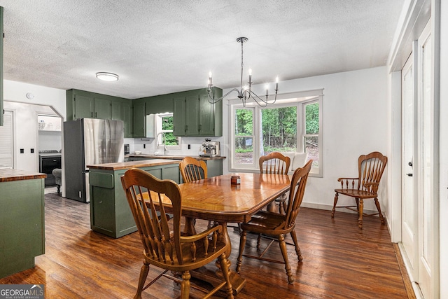 211 Phillips St, Clarkesville, GA 30523 - dining area with a chandelier, dark wood-type flooring, plenty of natural light, a textured ceiling, and baseboards