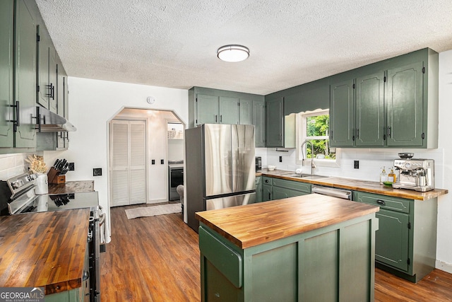 211 Phillips St, Clarkesville, GA 30523 - kitchen featuring wooden counters, green cabinetry, appliances with stainless steel finishes, a sink, and under cabinet range hood