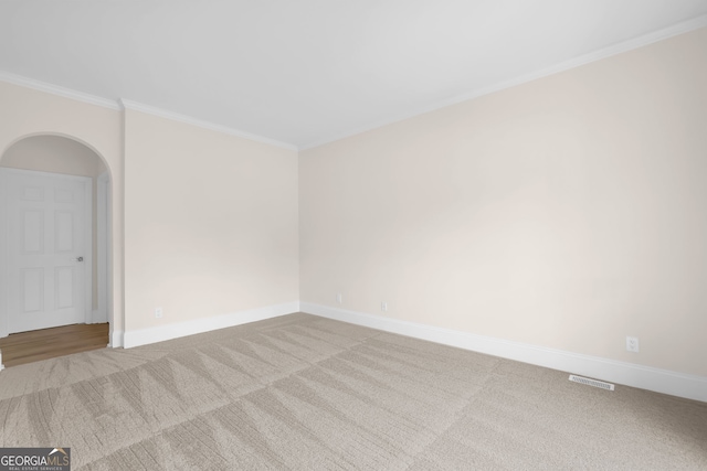 2111 Fernbank Way, Dacula, GA 30019 - spare room featuring carpet flooring, baseboards, arched walkways, and crown molding