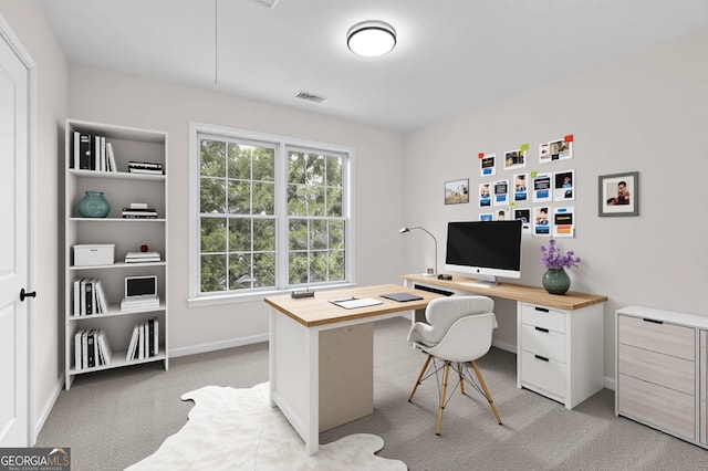 office space with baseboards, attic access, visible vents, and light colored carpet