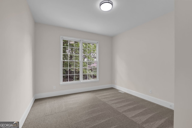 empty room with carpet and baseboards