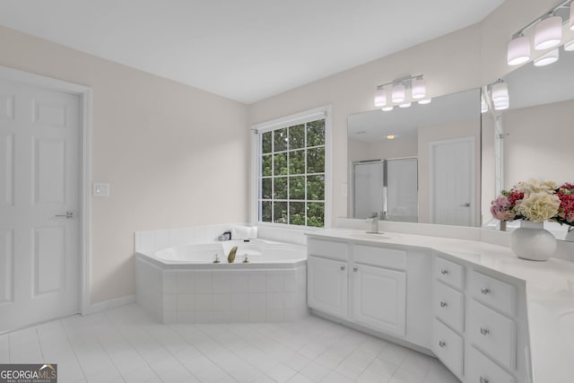 full bathroom featuring a bath, a stall shower, tile patterned flooring, and vanity