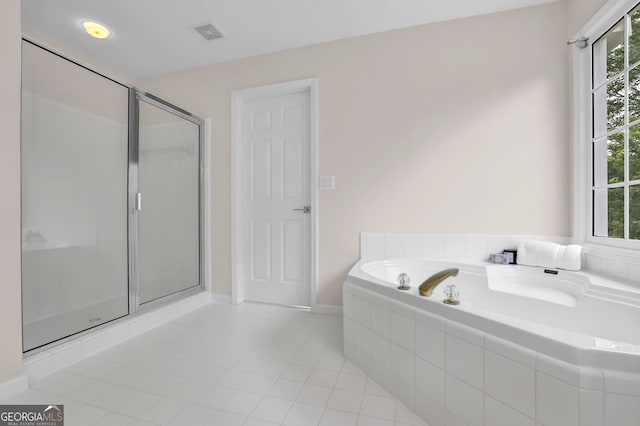 bathroom with a garden tub, tile patterned floors, plenty of natural light, visible vents, and a shower stall