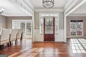 2656 Old Norcross Rd, Tucker, GA 30084 - entrance foyer featuring a chandelier, ornamental molding, wood finished floors, and a wainscoted wall