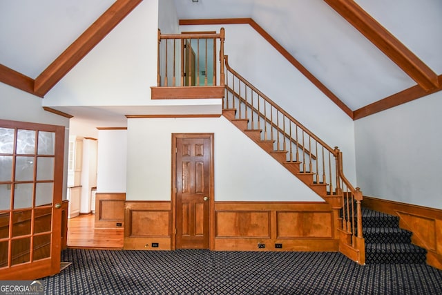 615 Woodwork Way, Roswell, GA 30076 - staircase with carpet floors, a wainscoted wall, and high vaulted ceiling