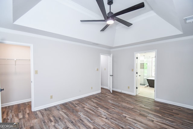 615 Woodwork Way, Roswell, GA 30076 - unfurnished bedroom with a walk in closet, ornamental molding, and wood finished floors