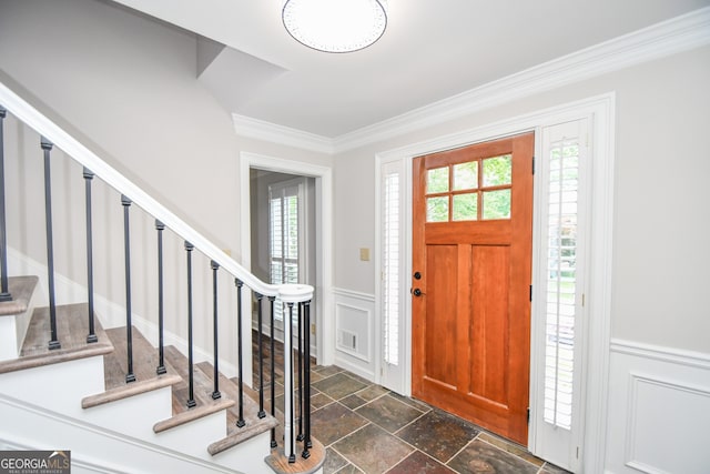 615 Woodwork Way, Roswell, GA 30076 - foyer entrance featuring ornamental molding, a decorative wall, stairs, and stone tile flooring