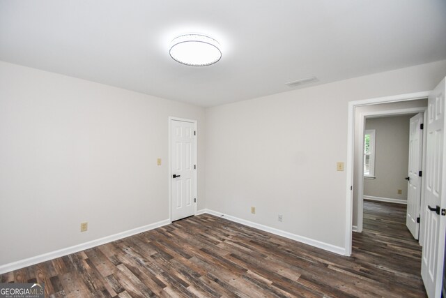 615 Woodwork Way, Roswell, GA 30076 - empty room featuring dark wood-type flooring, baseboards, and visible vents