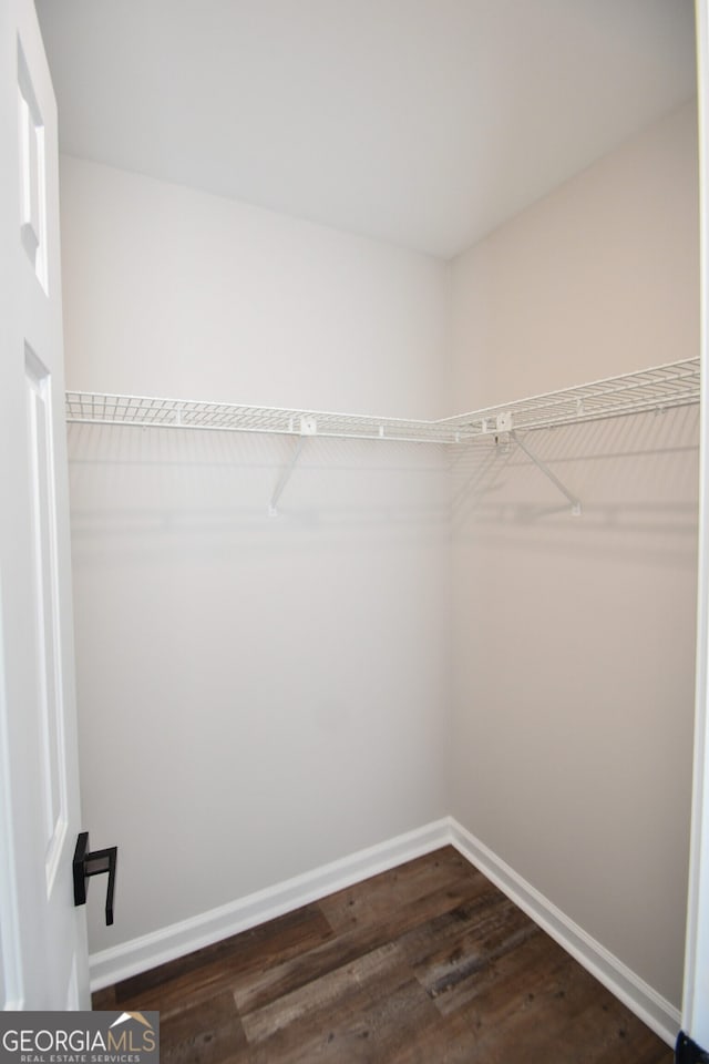 615 Woodwork Way, Roswell, GA 30076 - spacious closet featuring dark wood-type flooring