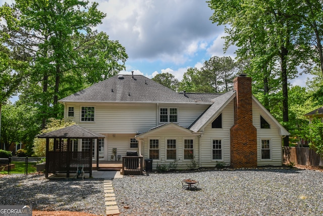 615 Woodwork Way, Roswell, GA 30076 - back of house featuring a chimney, a fire pit, fence, and a deck