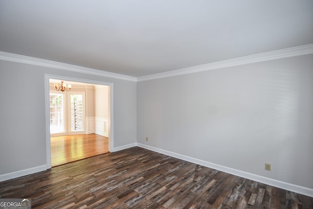 615 Woodwork Way, Roswell, GA 30076 - empty room with crown molding, dark wood-style flooring, baseboards, and a chandelier