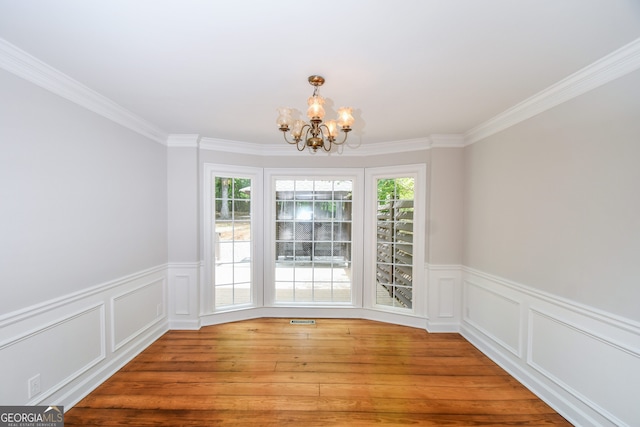 615 Woodwork Way, Roswell, GA 30076 - unfurnished dining area featuring crown molding, wainscoting, and a chandelier