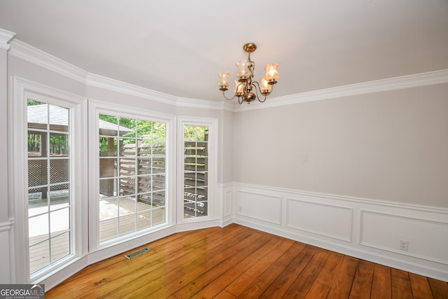 615 Woodwork Way, Roswell, GA 30076 - empty room with an inviting chandelier, ornamental molding, hardwood / wood-style floors, and visible vents