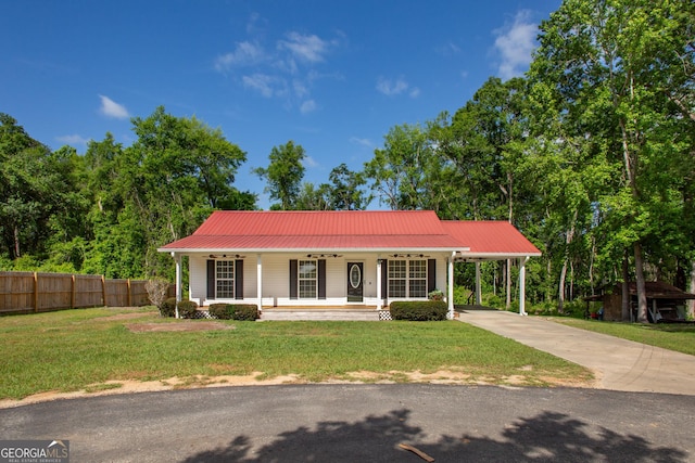 view of front of house with covered porch, ceiling fan, a front yard, fence, and concrete driveway