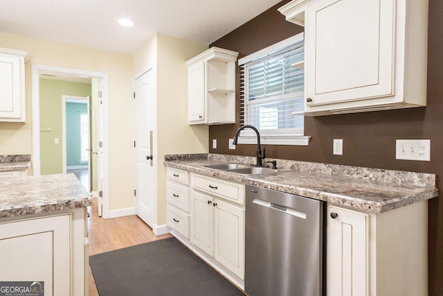 19 Live Oak Ln, Waycross, GA 31503 - kitchen featuring dishwasher, light wood finished floors, open shelves, light countertops, and white cabinets