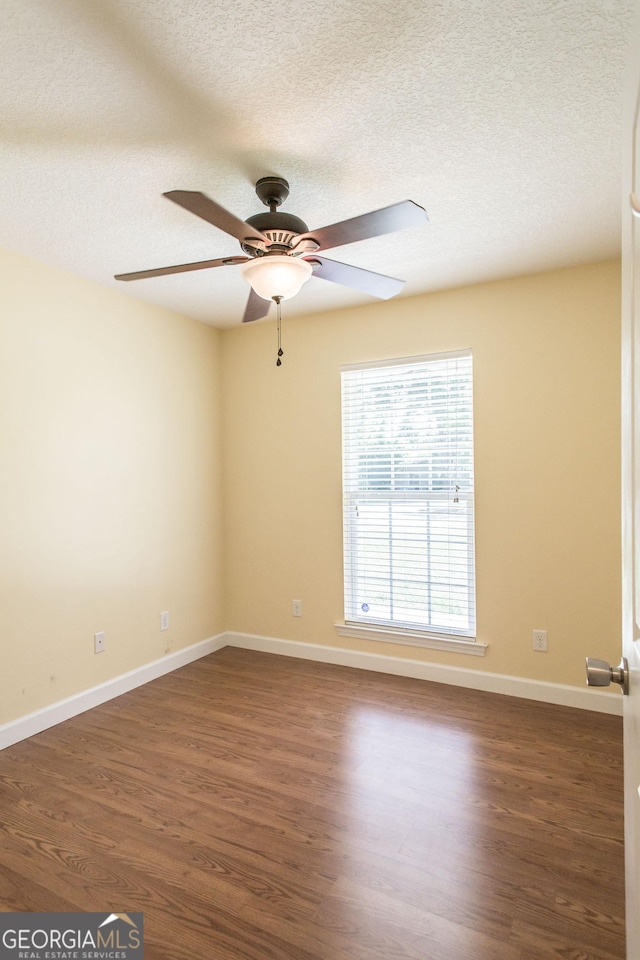 19 Live Oak Ln, Waycross, GA 31503 - spare room featuring a textured ceiling, a ceiling fan, and dark wood-style floors