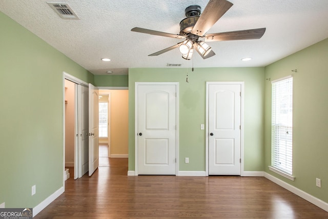 19 Live Oak Ln, Waycross, GA 31503 - unfurnished bedroom featuring dark wood finished floors, multiple windows, a textured ceiling, recessed lighting, and ceiling fan