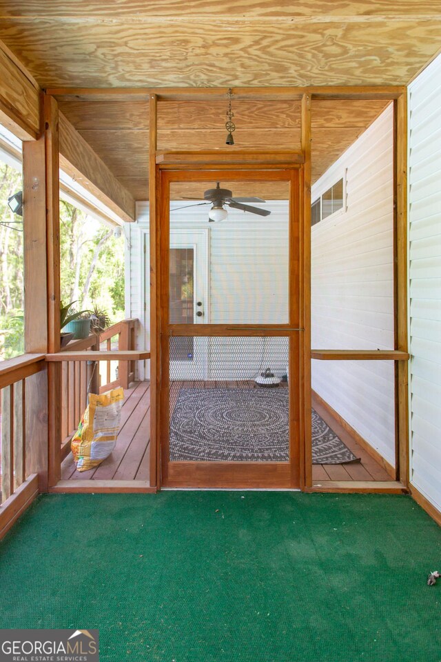 unfurnished sunroom with a ceiling fan and a healthy amount of sunlight
