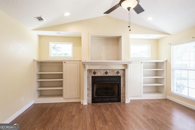 19 Live Oak Ln, Waycross, GA 31503 - unfurnished living room featuring lofted ceiling, ceiling fan, wood finished floors, a fireplace, and healthy amount of natural light