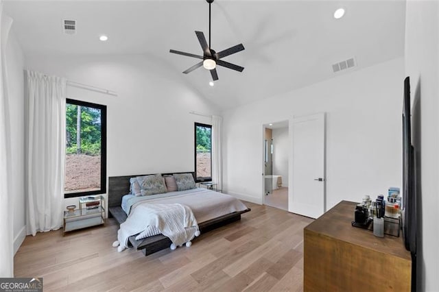 bedroom with light wood-type flooring, vaulted ceiling, recessed lighting, and visible vents