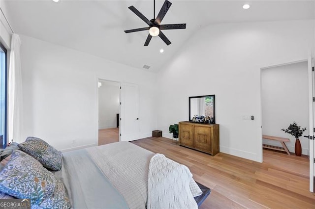 bedroom with light wood-style floors, high vaulted ceiling, multiple windows, and recessed lighting