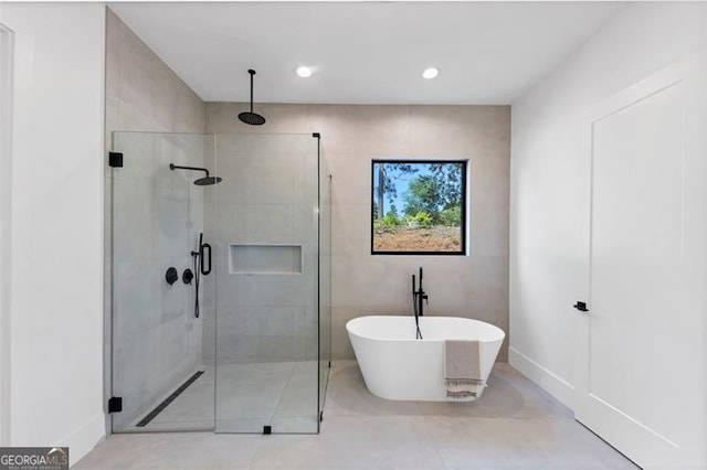full bathroom featuring tile patterned floors, recessed lighting, a freestanding tub, baseboards, and a stall shower
