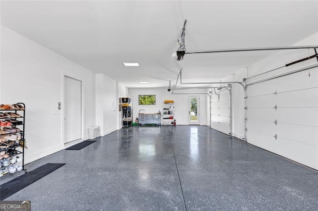 garage with baseboards and a garage door opener