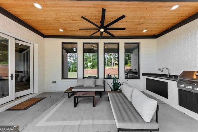 view of patio / terrace featuring ceiling fan, french doors, area for grilling, an outdoor living space, and exterior kitchen