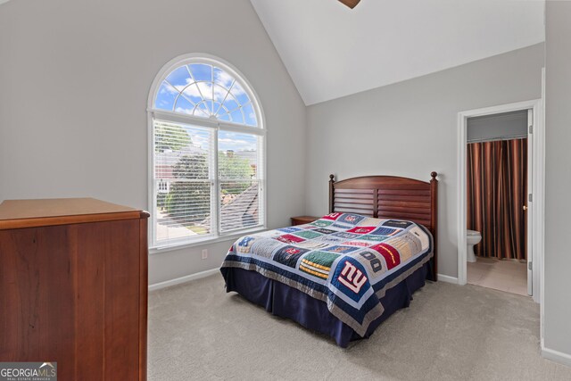 bedroom featuring baseboards, carpet flooring, vaulted ceiling, and multiple windows