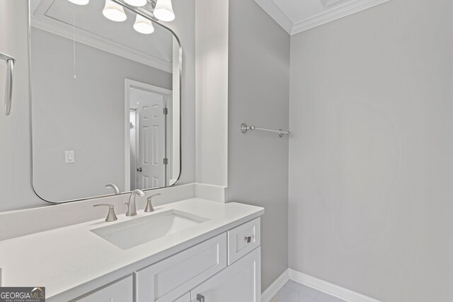 bathroom with crown molding, baseboards, and vanity